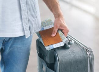 ECP Gets You There Safely (They ‘Air’ on the Side of Caution) Man Holding His Passport And Carrying Suitcase, Close Up